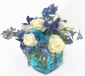 Blue hydrangea, iris and delphinium in various shades of blue sit amongst delicate white roses.