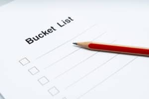 White paper bucket list with red pencil